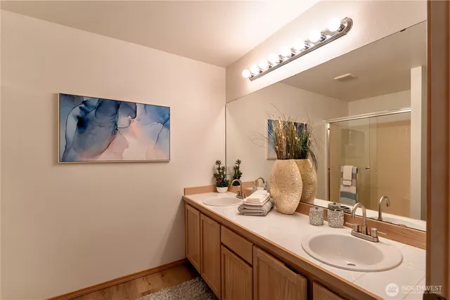 a bathroom with a sink vanity and a mirror