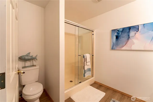 a bathroom with a toilet and a shower