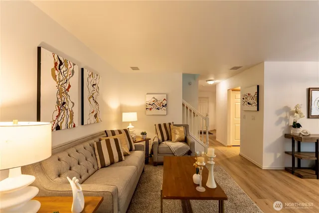 a living room with furniture and wooden floor