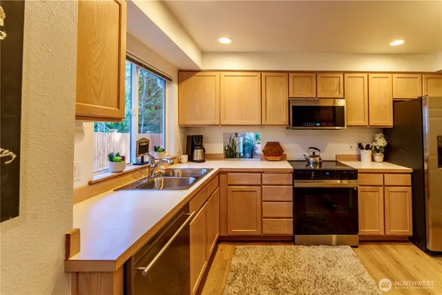 a kitchen with a sink cabinets and appliances