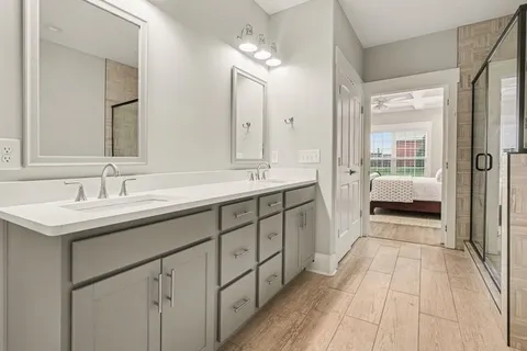 a spacious bathroom with a double vanity sink and a mirror