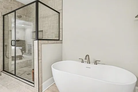 a bathroom with a bathtub and shower
