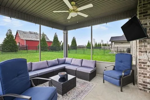 a view of a patio with couches chairs and a yard