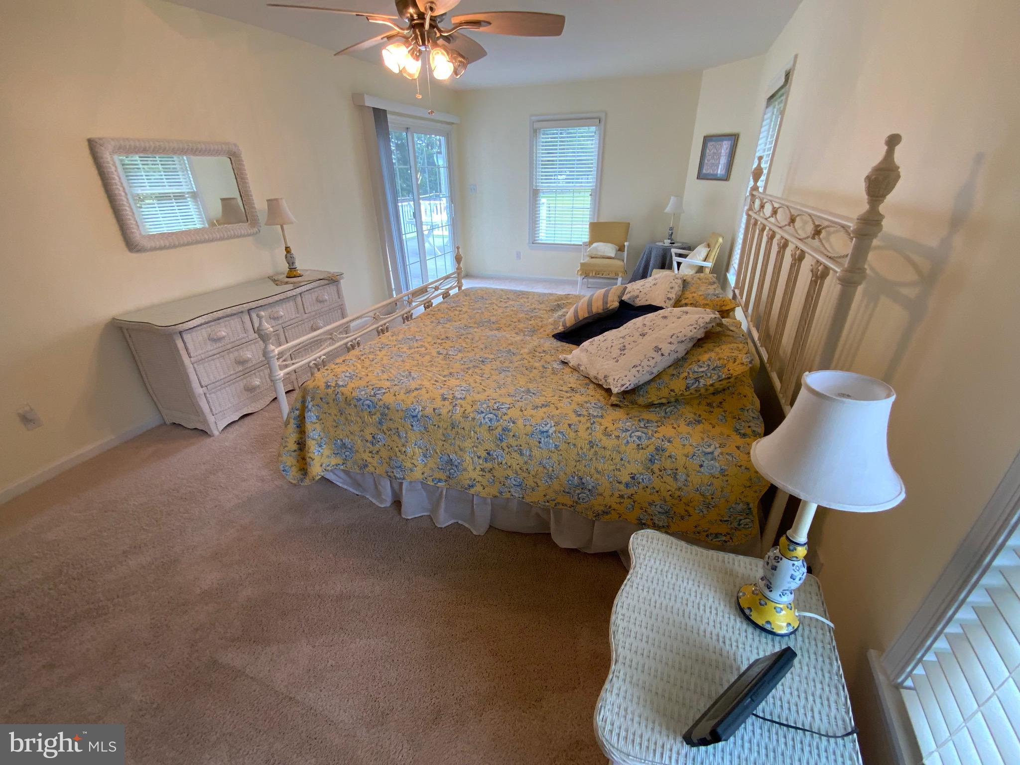 38211 Marlington Road Ocean View, DE 19970 - Photo 24 of 56 a bedroom with furniture and a chandelier