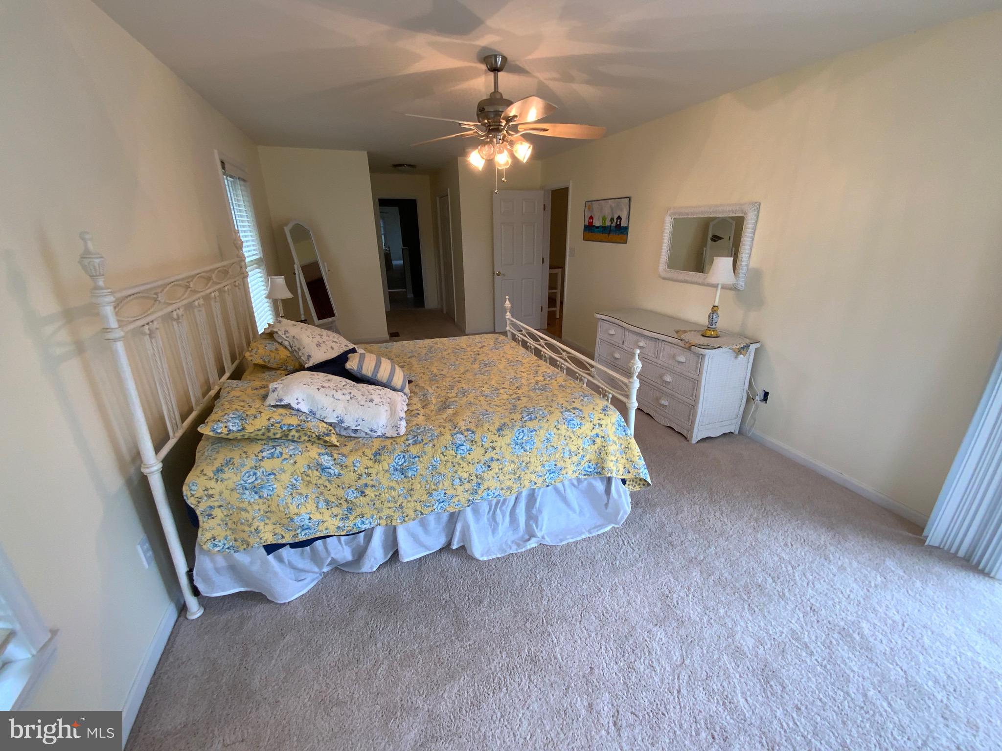 38211 Marlington Road Ocean View, DE 19970 - Photo 25 of 56 a bed sitting in a spacious bedroom next to a window