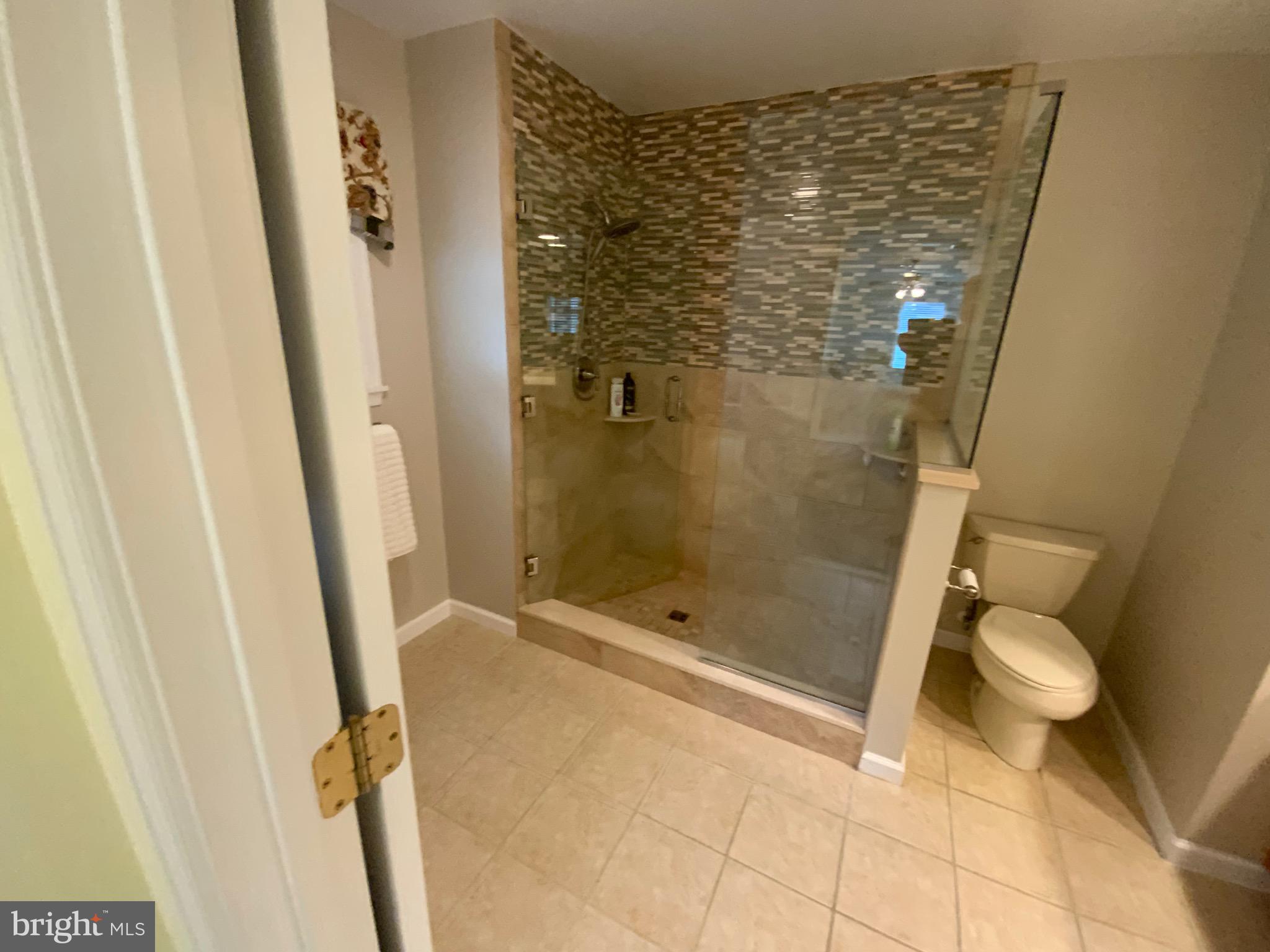 38211 Marlington Road Ocean View, DE 19970 - Photo 27 of 56 a bathroom with a granite countertop shower and a toilet