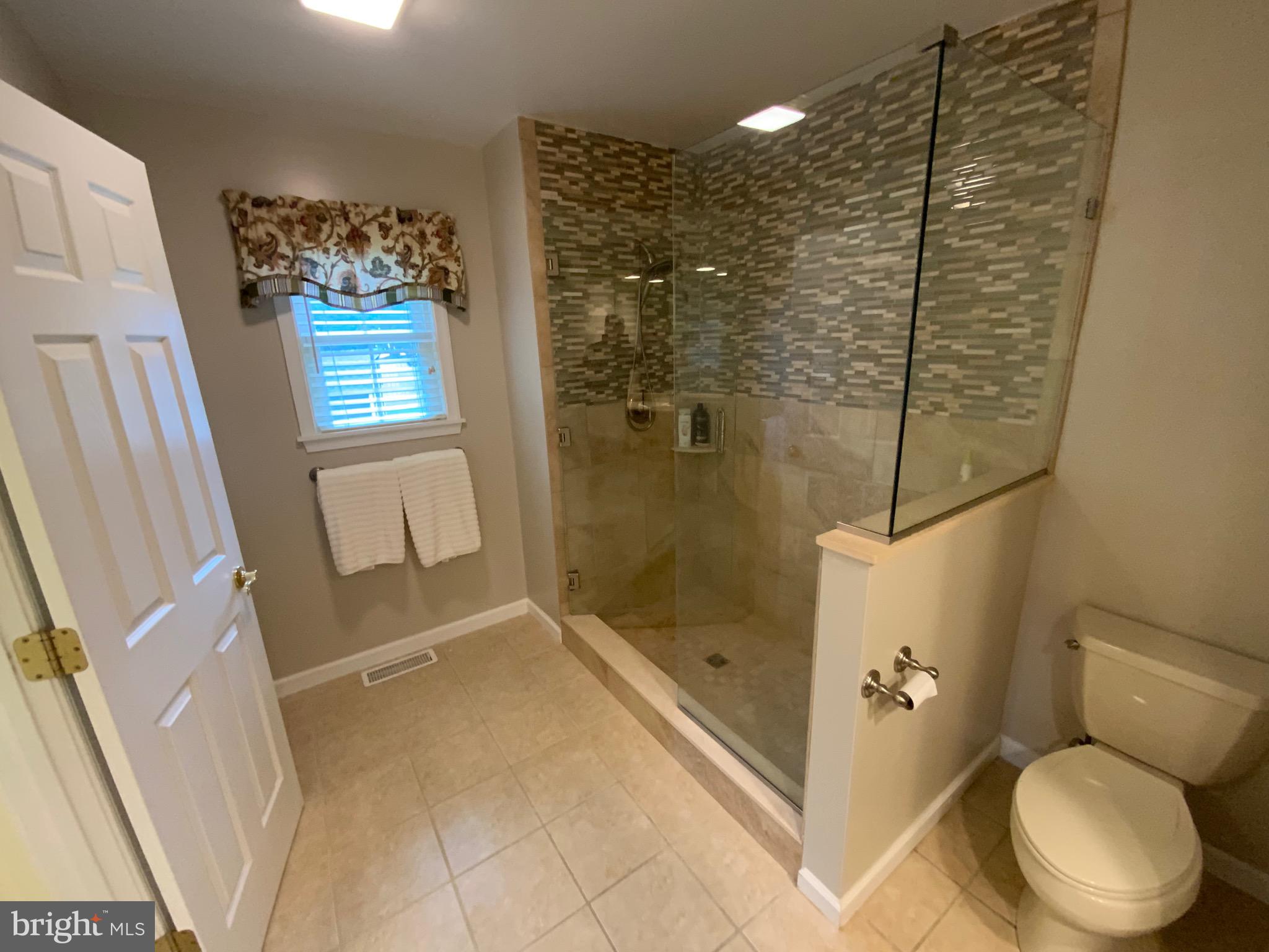 38211 Marlington Road Ocean View, DE 19970 - Photo 28 of 56 a bathroom with a toilet and shower