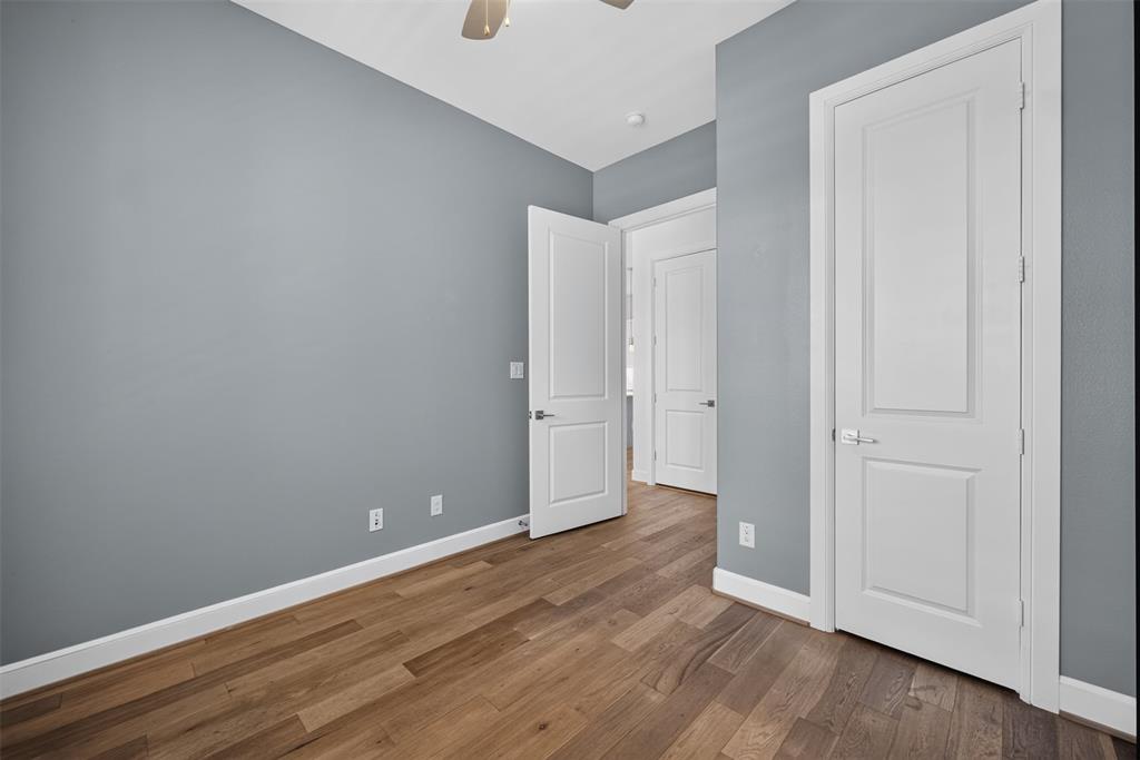 5015 Meridian Lane, Unit 2102 Addison, TX 75001 - Photo 13 of 36 Interior room featuring wood-finish flooring, light gray wall paint, and white baseboards