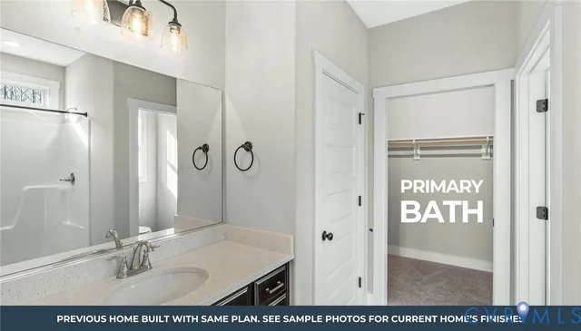 a bathroom with a sink a mirror and a shower