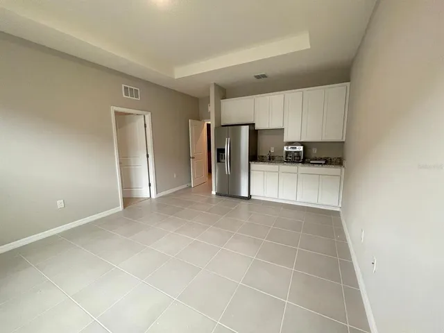 an empty room with sliding door and wooden floor