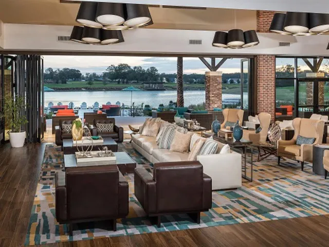 a view of a house with swimming pool and sitting area