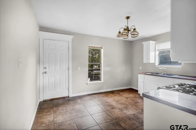 a kitchen with granite countertop white cabinets and white appliances