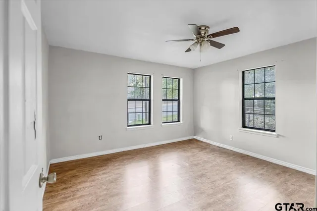 wooden floor in an empty room with a window