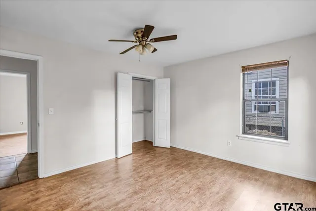 a view of a room with wooden floor and closet