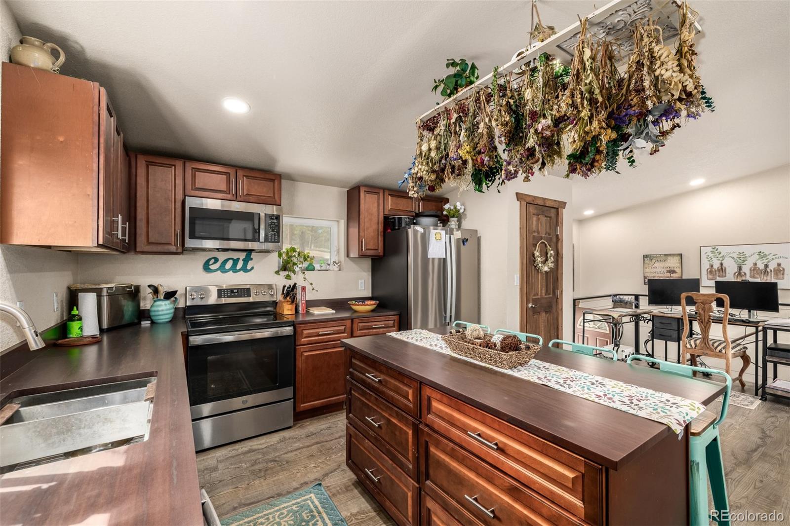 752 Impala Trail Bailey, CO 80421 - Photo 12 of 50 a kitchen with stainless steel appliances granite countertop a stove a sink and a refrigerator