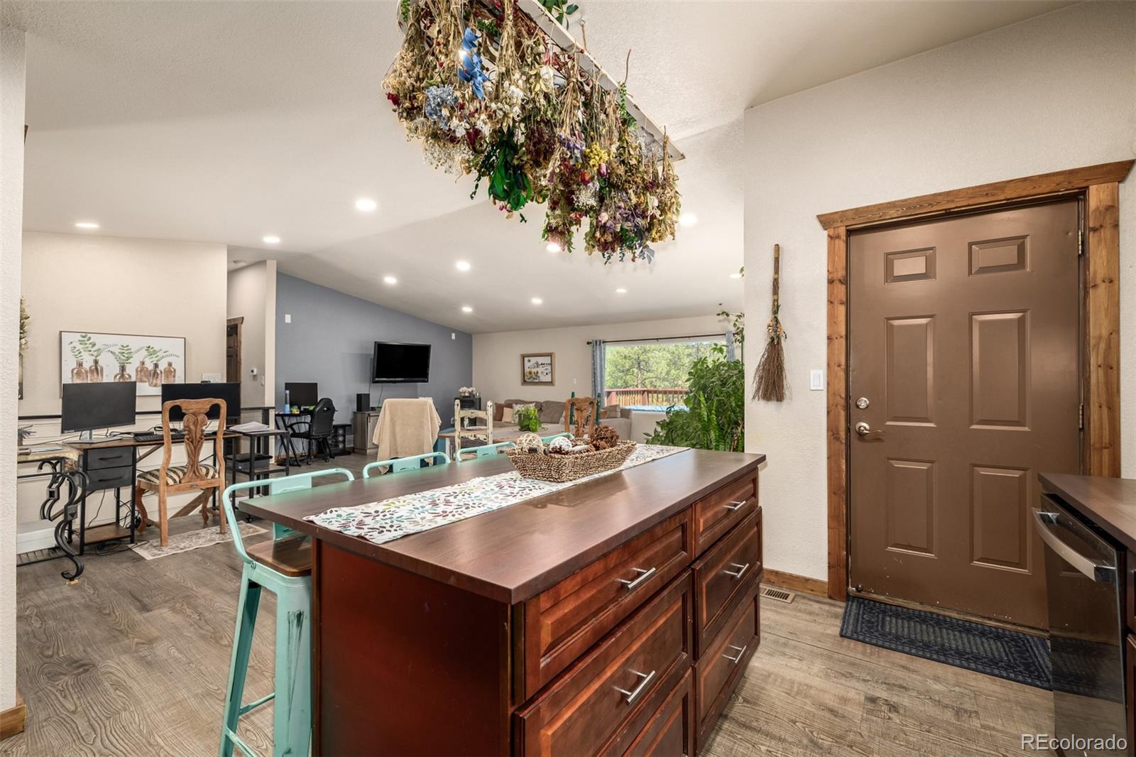 752 Impala Trail Bailey, CO 80421 - Photo 13 of 50 a kitchen with a sink a counter and chairs