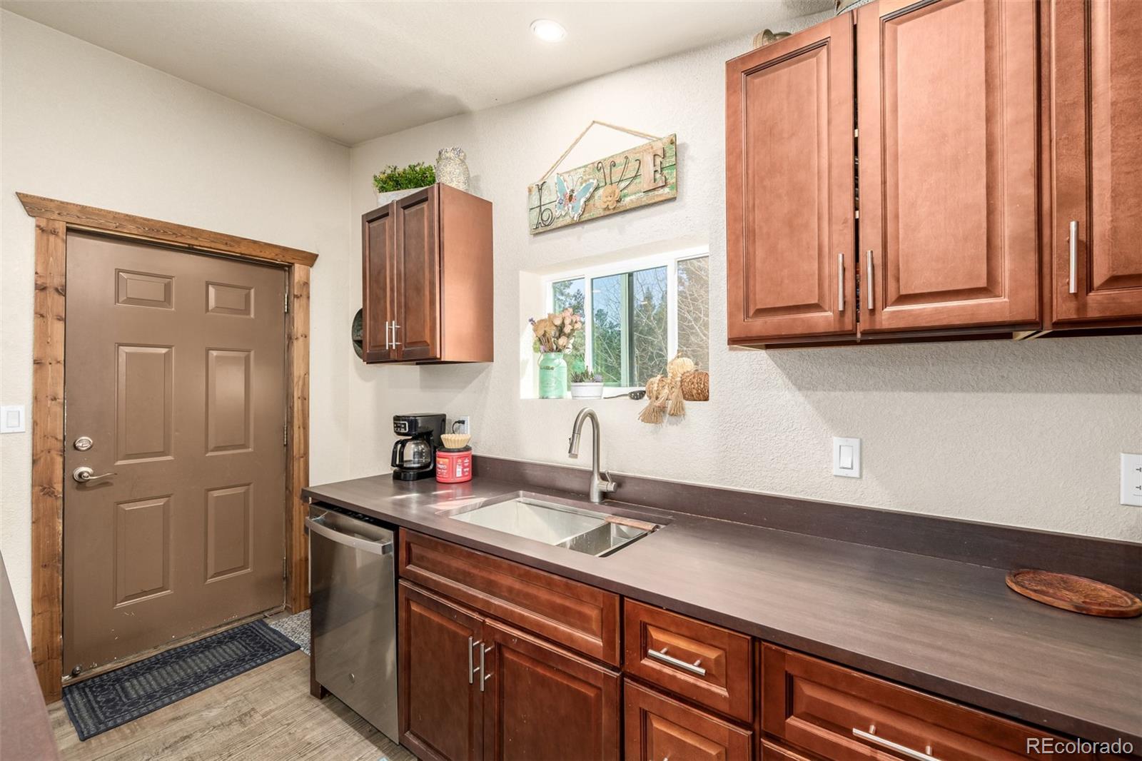 752 Impala Trail Bailey, CO 80421 - Photo 14 of 50 a kitchen with a sink and a refrigerator