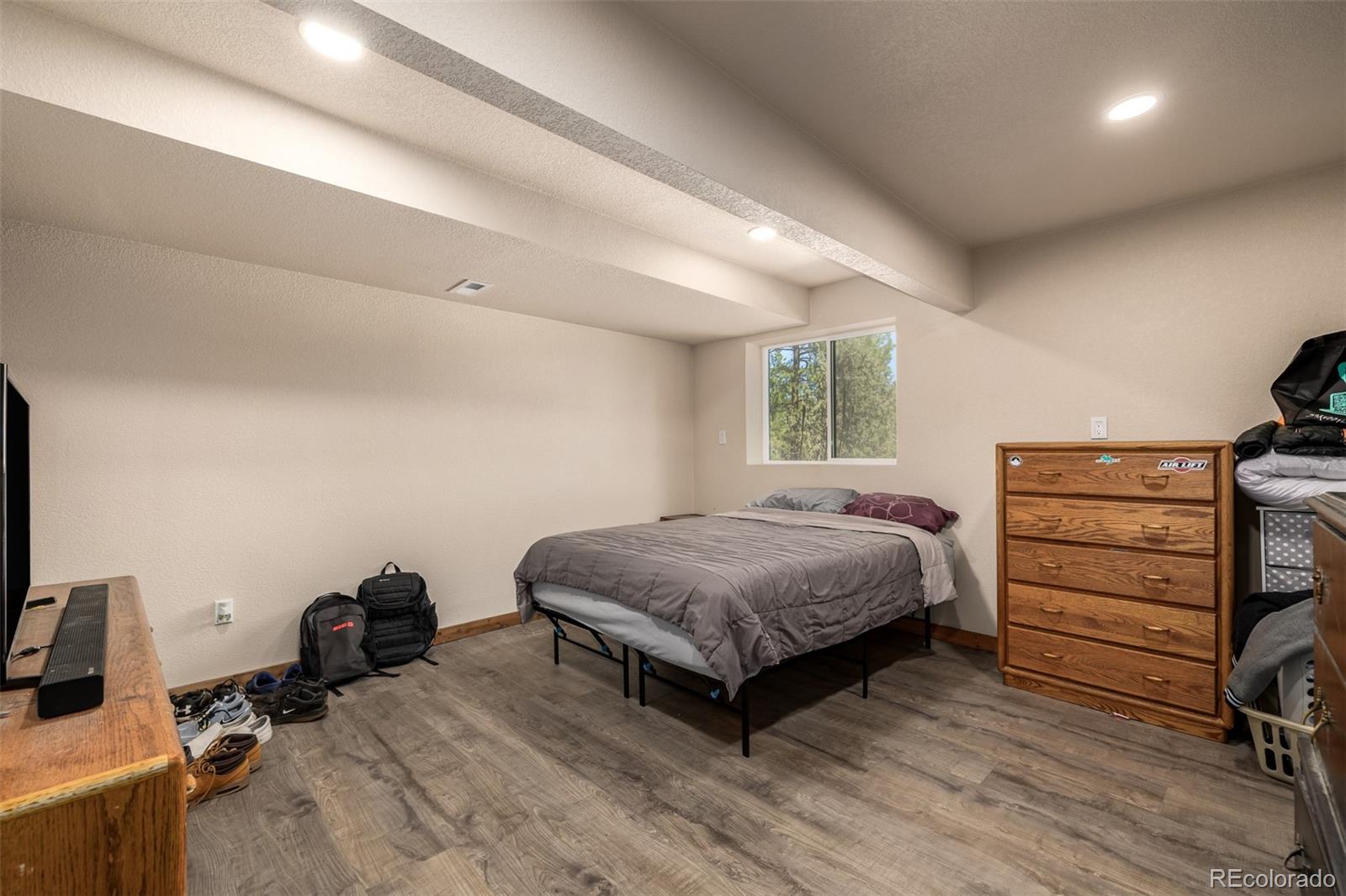 752 Impala Trail Bailey, CO 80421 - Photo 23 of 50 a bedroom with a bed and a chair