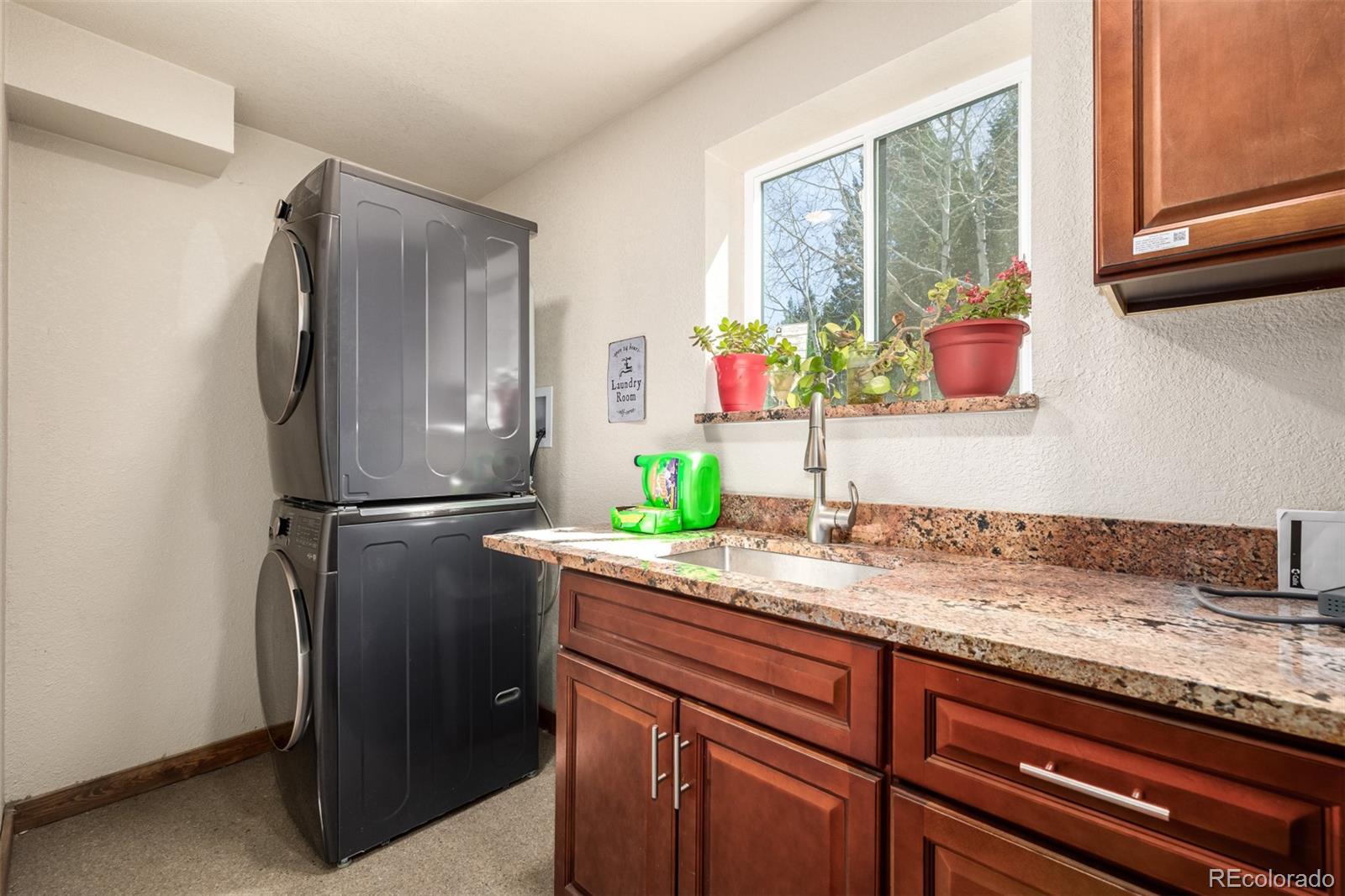 752 Impala Trail Bailey, CO 80421 - Photo 28 of 50 a kitchen with stainless steel appliances granite countertop a refrigerator and a sink
