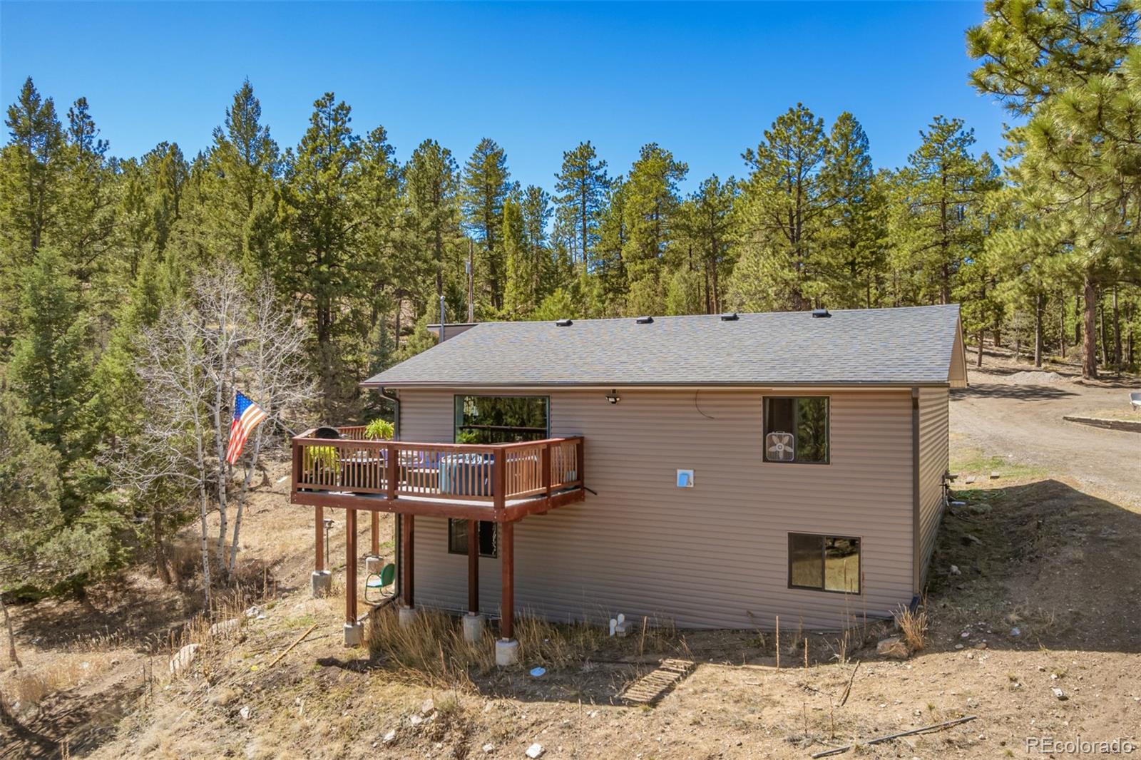 752 Impala Trail Bailey, CO 80421 - Photo 35 of 50 a front view of a house with a yard