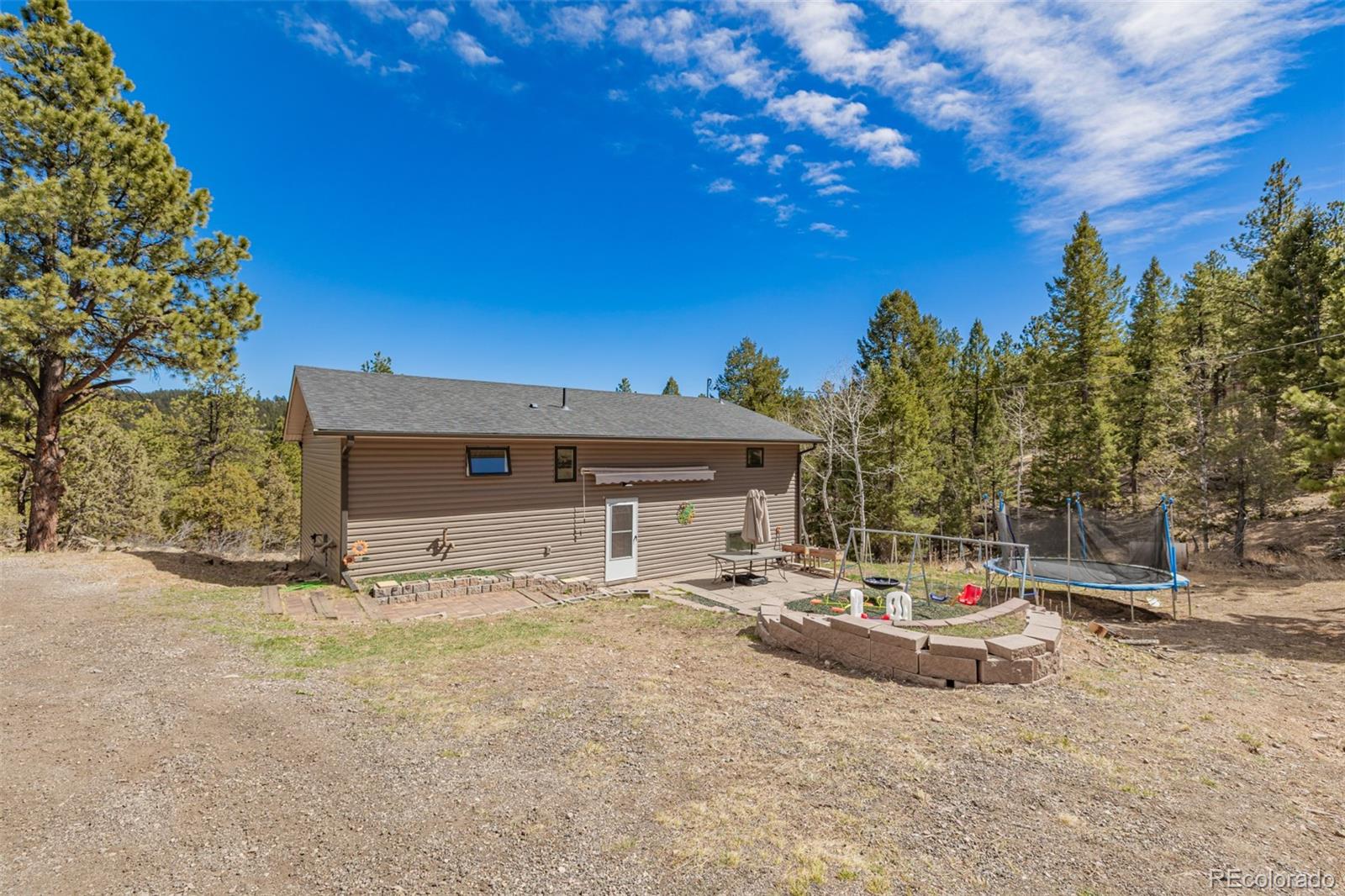 752 Impala Trail Bailey, CO 80421 - Photo 4 of 50 a view of a white house with a yard