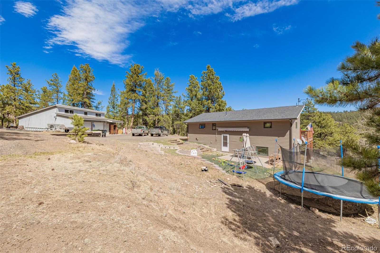 752 Impala Trail Bailey, CO 80421 - Photo 46 of 50 a view of a backyard with a sitting area