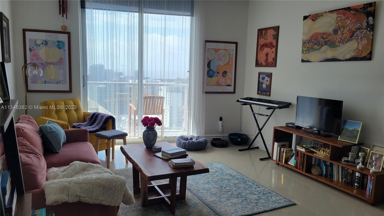 185 Southwest 7th Street, Unit 3308 Miami, FL 33130 - Photo 5 of 6 a living room with furniture and a flat screen tv