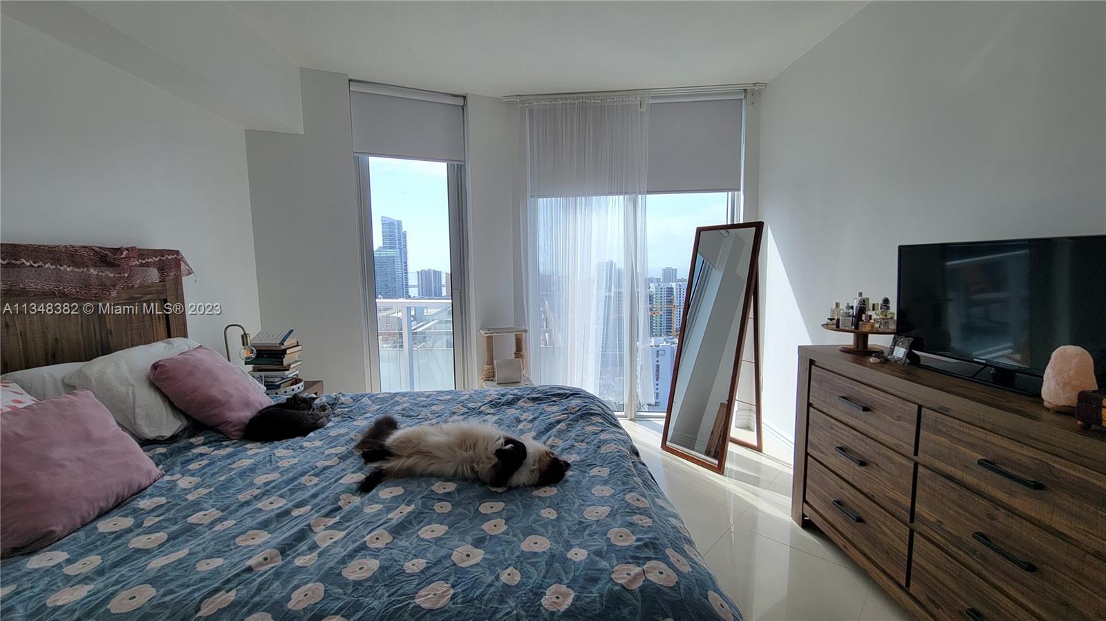 185 Southwest 7th Street, Unit 3308 Miami, FL 33130 - Photo 6 of 6 a bedroom with a bed and a flat screen television