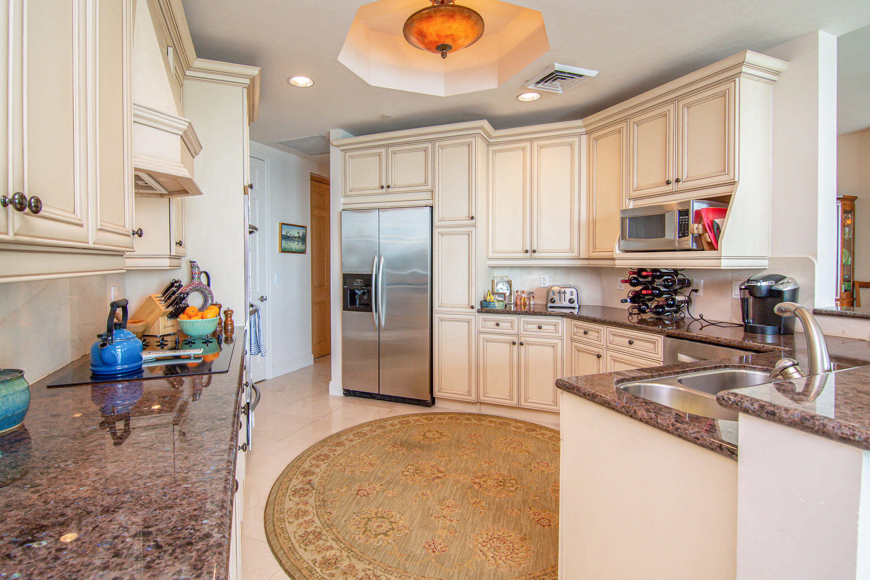 1069 Bald Eagle Drive, Unit S803 Marco Island, FL 34145 - Photo 6 of 41 a kitchen with stainless steel appliances granite countertop a sink refrigerator and cabinets