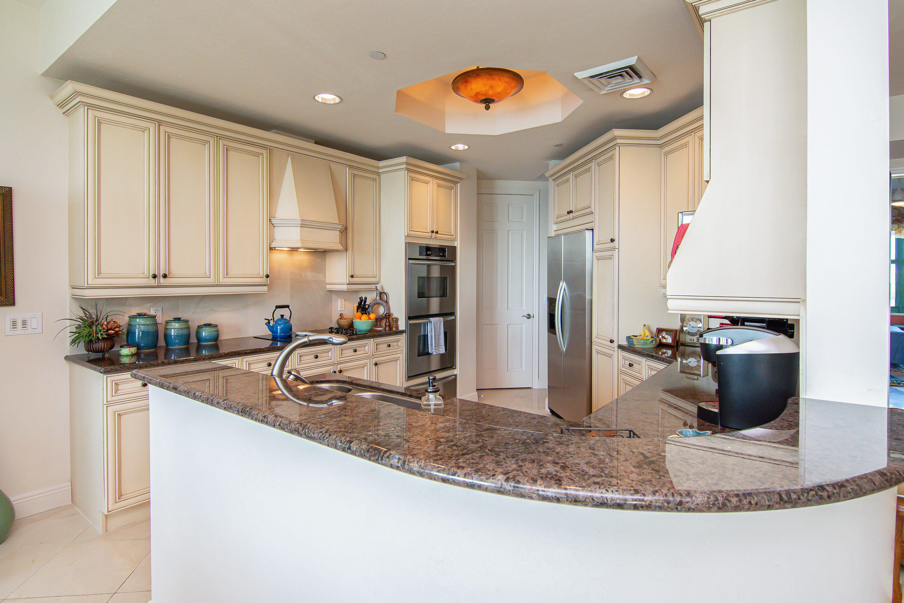 1069 Bald Eagle Drive, Unit S803 Marco Island, FL 34145 - Photo 7 of 41 a kitchen with stainless steel appliances granite countertop a sink refrigerator and cabinets