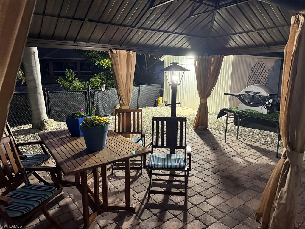27044 Williams Road Bonita Springs, FL 34135 - Photo 14 of 27 a view of a patio with table and chairs and wooden floor