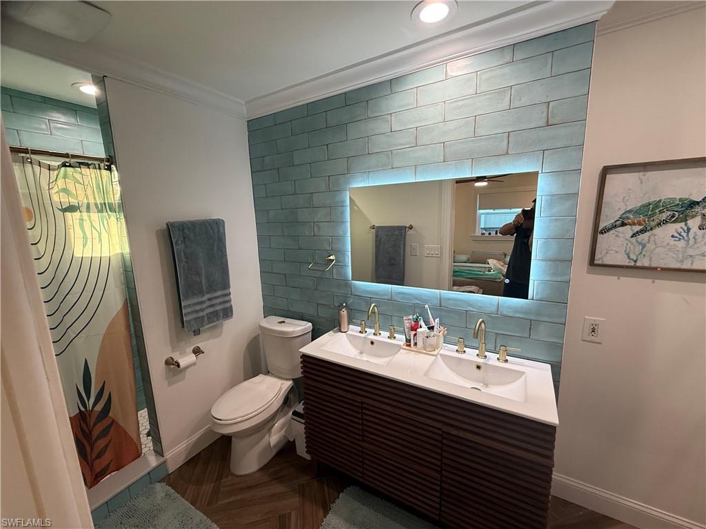 27044 Williams Road Bonita Springs, FL 34135 - Photo 15 of 27 a bathroom with a sink a toilet and mirror