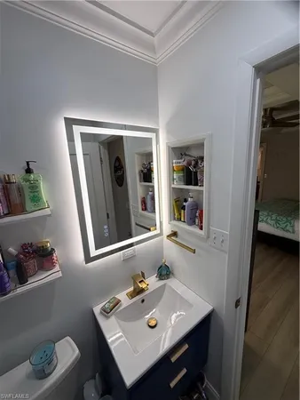 a bathroom with a sink toilet and a mirror