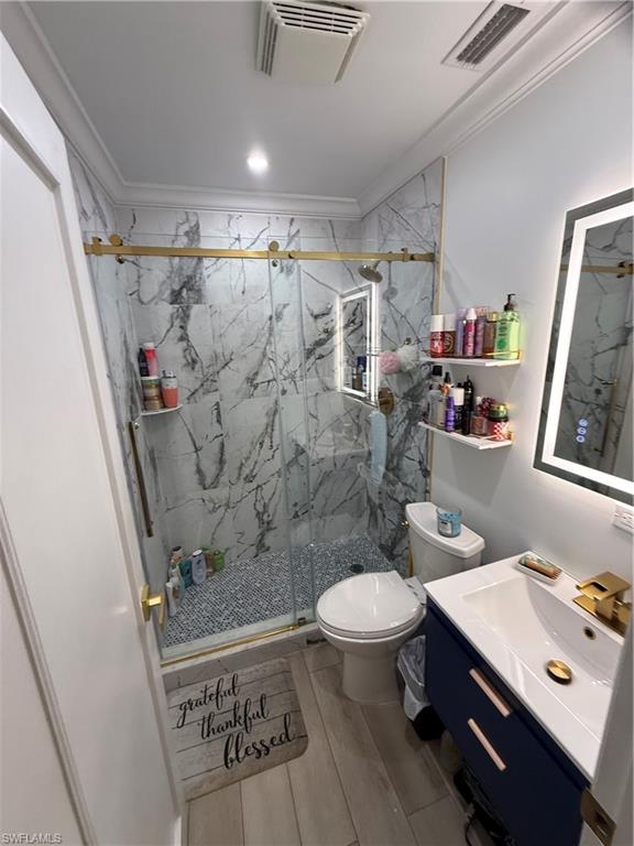 27044 Williams Road Bonita Springs, FL 34135 - Photo 17 of 27 a bathroom with a sink mirror vanity and toilet