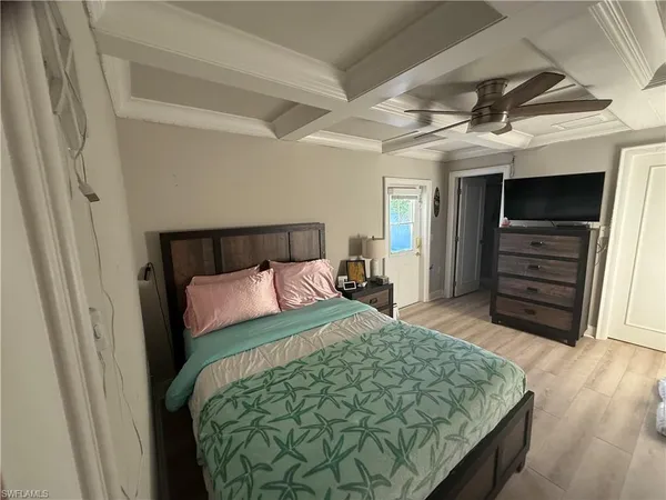 a bedroom with a bed and cabinet