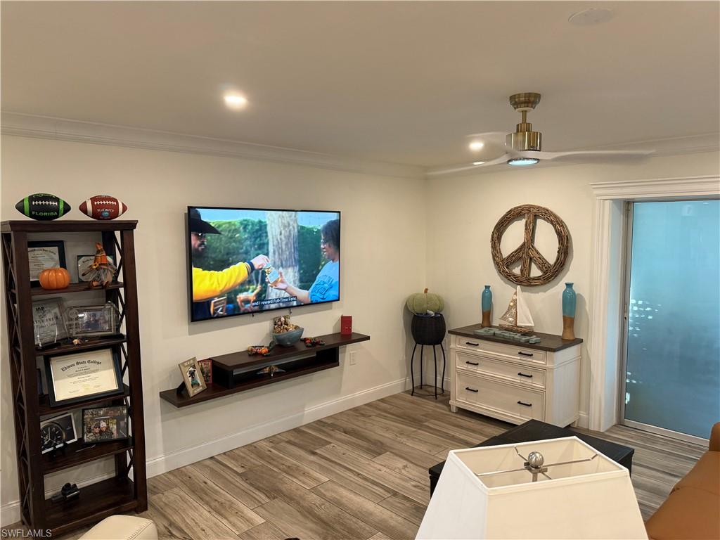 27044 Williams Road Bonita Springs, FL 34135 - Photo 20 of 27 a living room with furniture a flat screen tv and a mirror