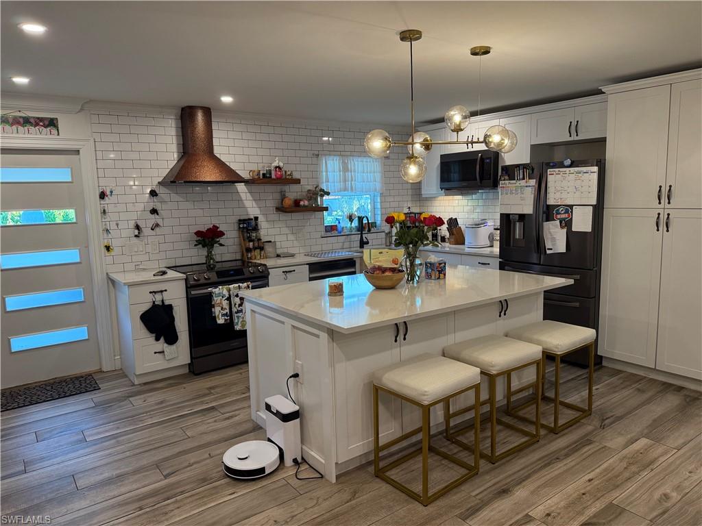 27044 Williams Road Bonita Springs, FL 34135 - Photo 21 of 27 a kitchen with a table chairs stove and cabinets
