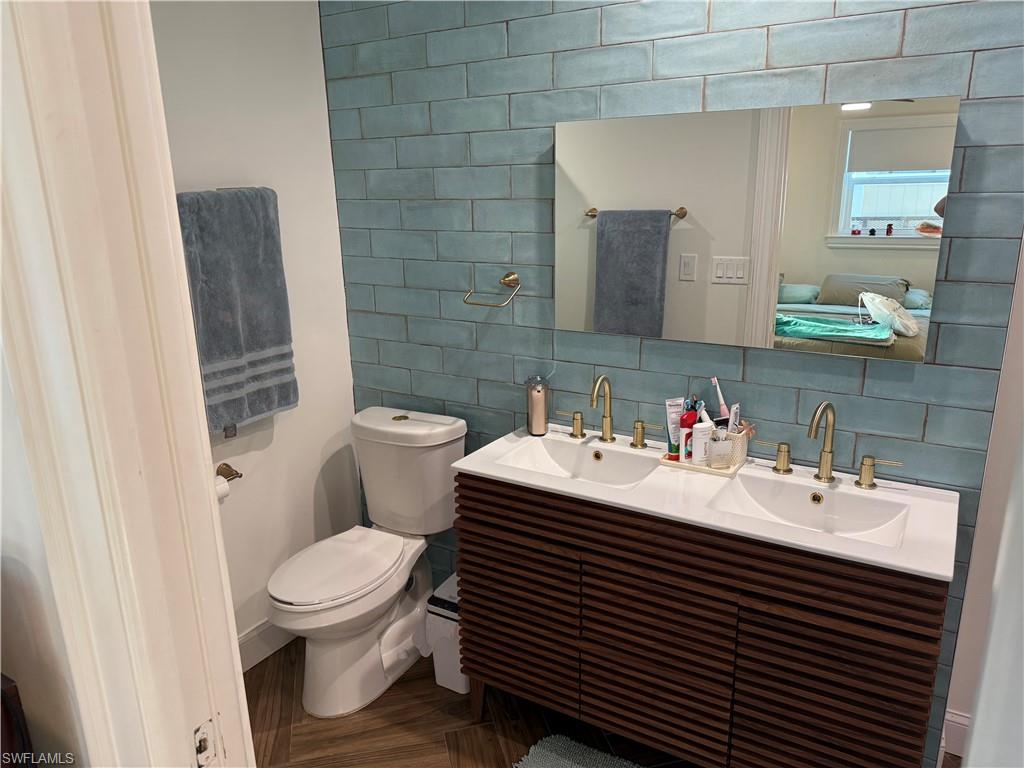 27044 Williams Road Bonita Springs, FL 34135 - Photo 25 of 27 a bathroom with a sink toilet and mirror