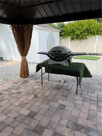 a backyard of a house with table and chairs