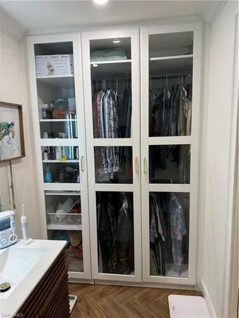 a view of a hallway with wooden floor and a window