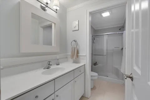 a bathroom with a shower a toilet and a sink