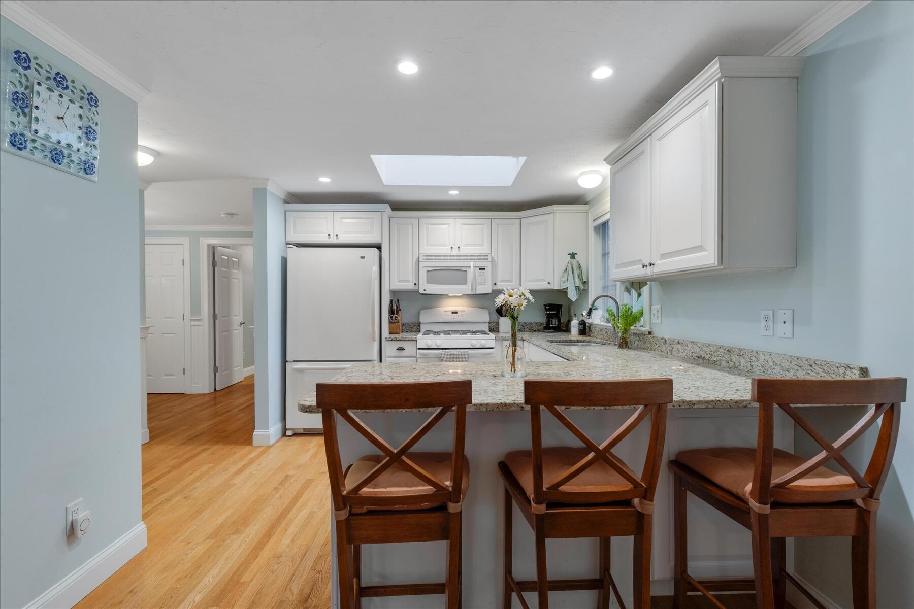 72 Dory Lane Eastham, MA 02642 - Photo 16 of 57 a kitchen with stainless steel appliances granite countertop a table chairs sink and cabinets