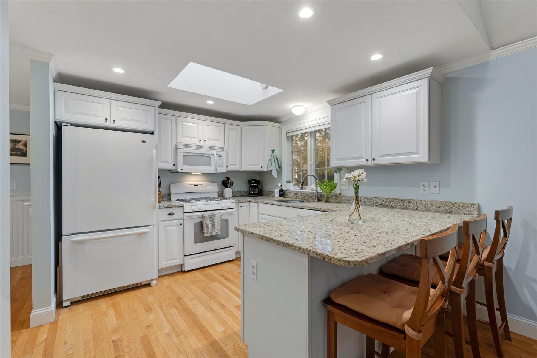 72 Dory Lane Eastham, MA 02642 - Photo 17 of 57 a kitchen with a refrigerator a stove a sink and white cabinets