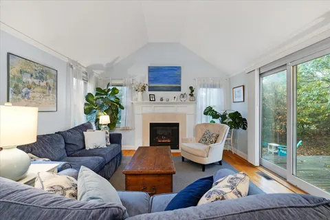 a living room with furniture ceiling fan and a wooden floor