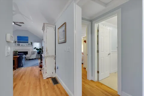 a bedroom with a bed and a flat tv screen on dresser