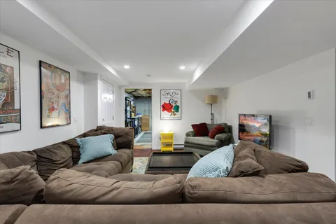 a view of living room filled with furniture and wooden floor