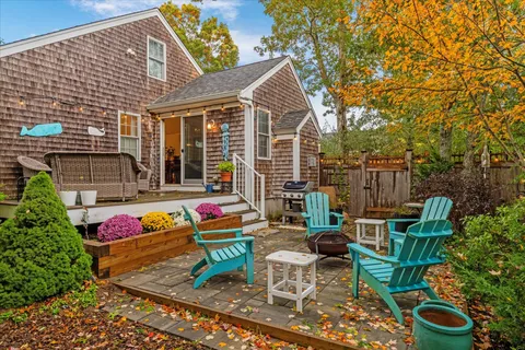 a view of a house with a wooden fence