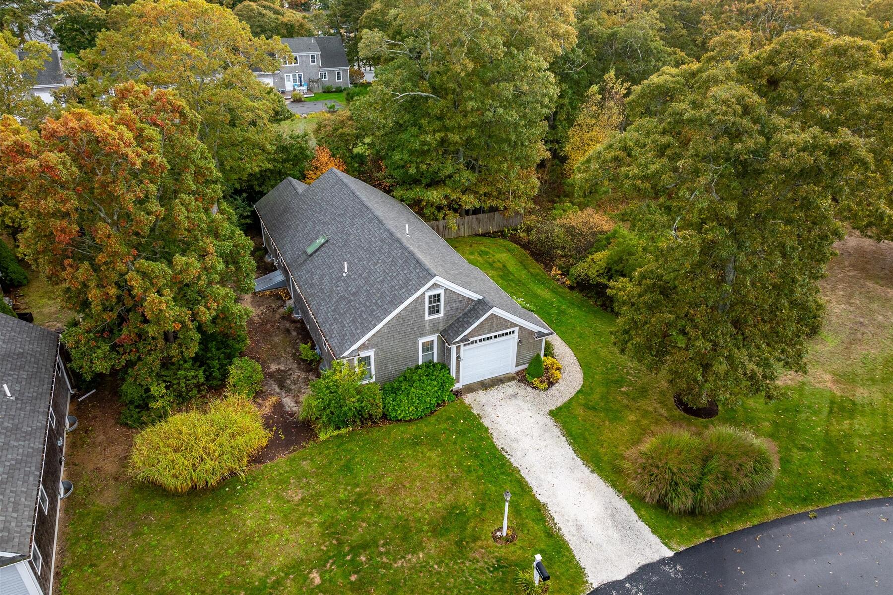 72 Dory Lane Eastham, MA 02642 - Photo 54 of 57 an aerial view of a house with a yard and trees