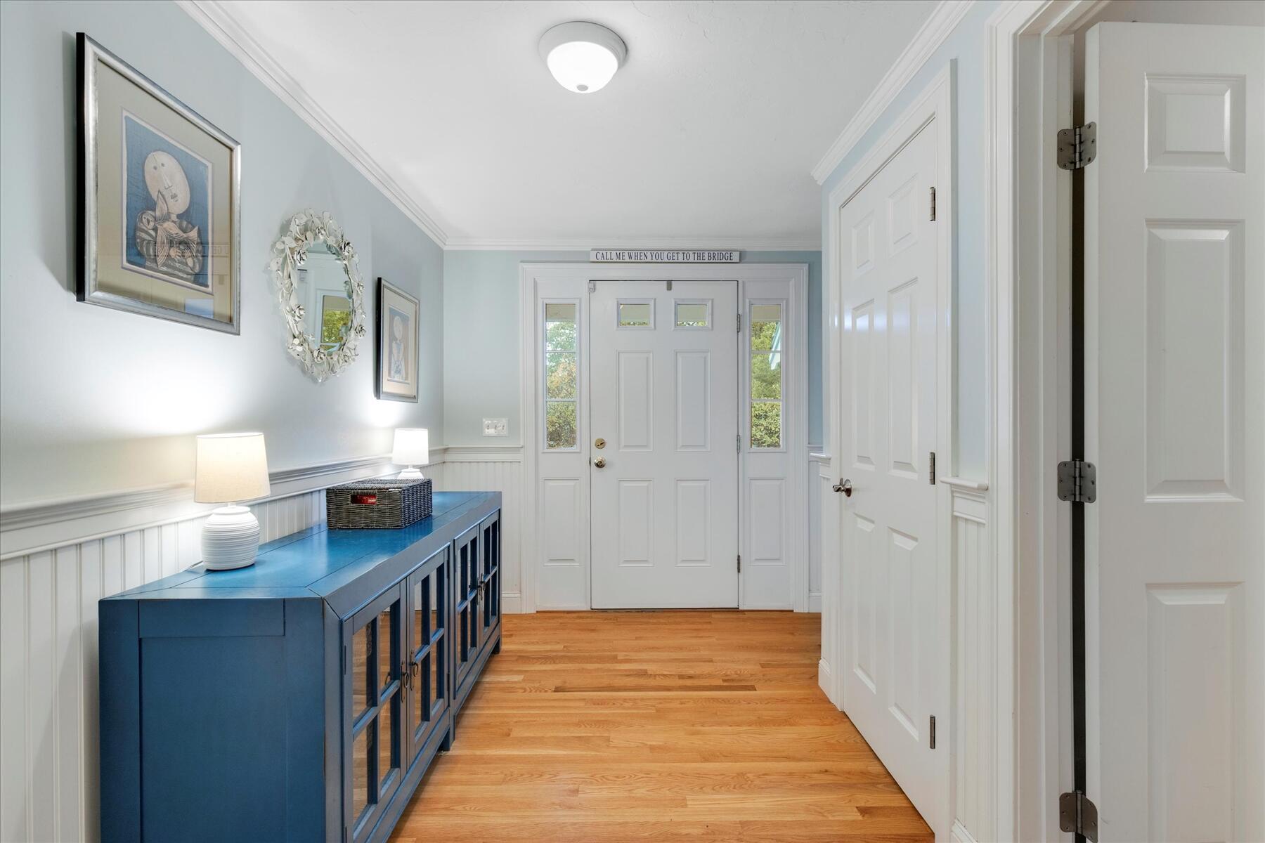 72 Dory Lane Eastham, MA 02642 - Photo 7 of 57 a view of a hallway to a bedroom with wooden floor and balcony