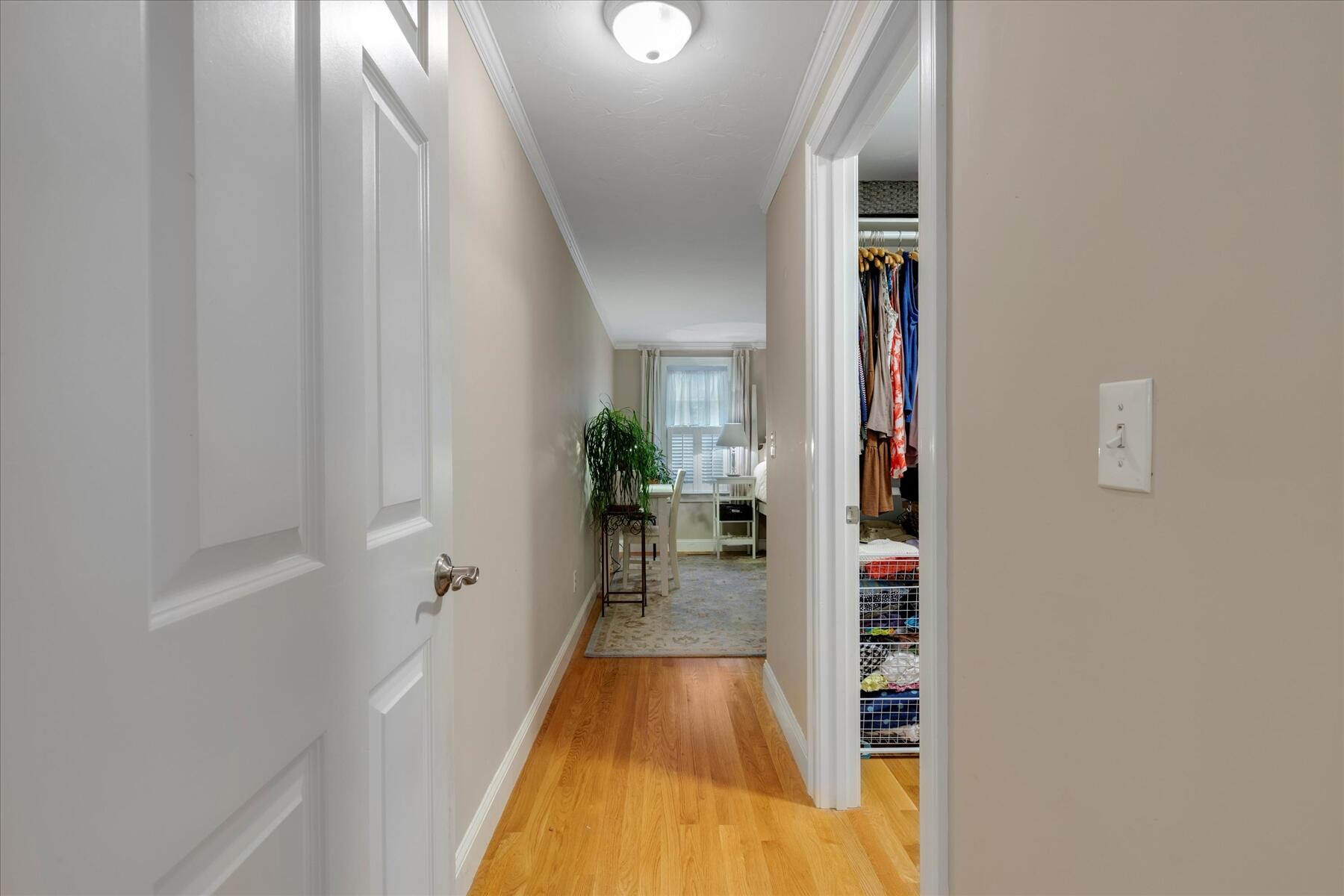 72 Dory Lane Eastham, MA 02642 - Photo 9 of 57 a view of a hallway with wooden floor and a living room